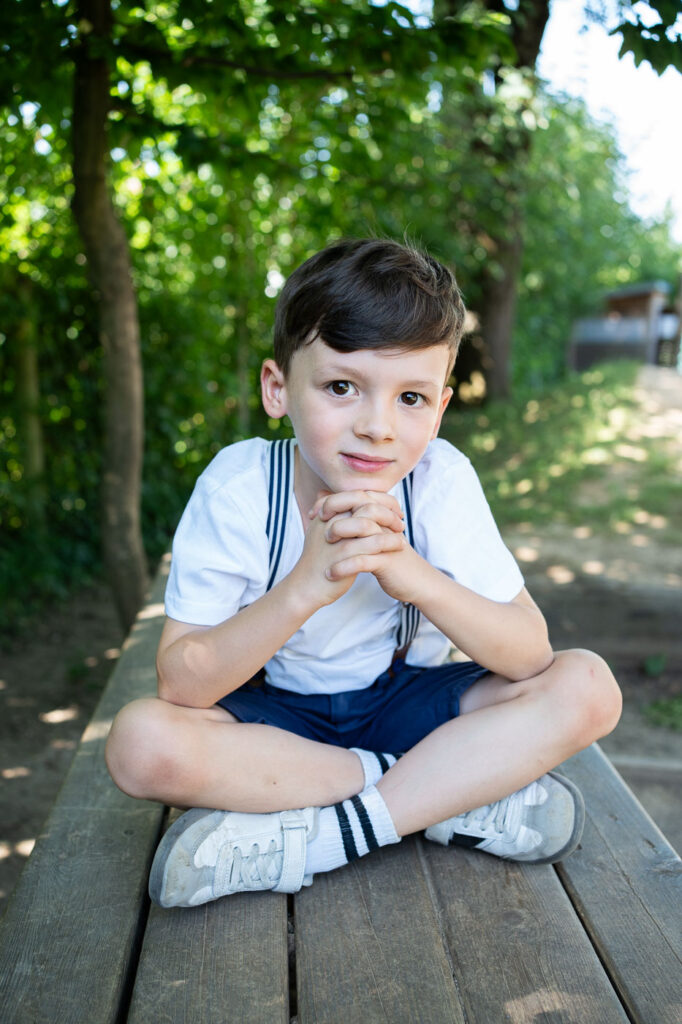 Junge im Schneidersitz, natürliche Kitafotografie, Kindergartenfotografie Esslingen Stuttgart